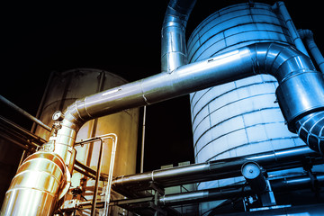 Pipeline and storage tanks at night, Chemical industrial concept