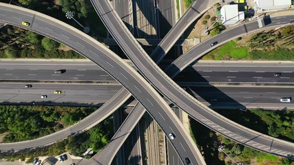 Wall Mural - Aerial drone video of urban multilevel highway junction with light traffic