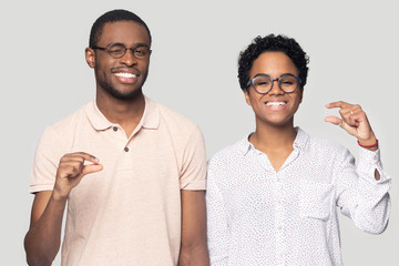 Sticker - Head shot happy African American couple showing little size gesture