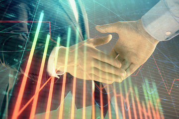 Multi exposure of forex graph on abstract background with two businessmen handshake. Concept of success on stock market