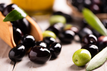 Black and Green olives on table .