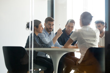 Concentrated diverse young team working process in office