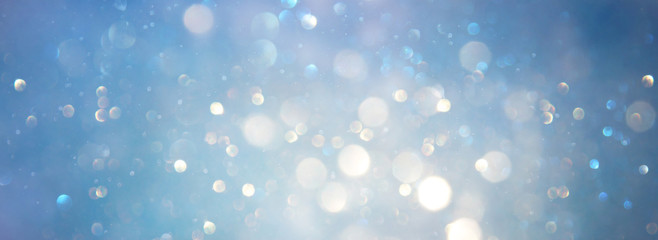 abstract glitter silver, gold , blue lights background. de-focused. banner