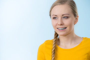 Wall Mural - Woman showing her teeth with braces