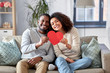 © Syda Productions - love, valentines day and relationships concept - happy african american couple holding red heart together at home