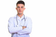 © Ranta Images - Studio shot of young handsome man doctor with arms crossed