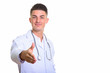 © Ranta Images - Young handsome man doctor giving handshake and smiling