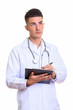 © Ranta Images - Young handsome man doctor writing on clipboard while thinking
