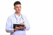 © Ranta Images - Young handsome man doctor writing on clipboard while thinking
