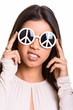 © Ranta Images - Brazilian woman wearing sunglasses with peace sign