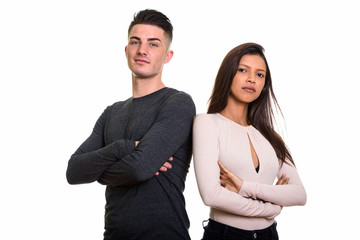 Wall Mural - Studio shot of young couple with arms crossed together