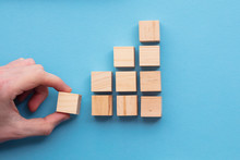 Hand Choosing A Wooden Block From A Set. Business Choice Concept