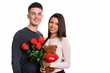 © Ranta Images - Young happy couple smiling while holding red roses and teddy bea