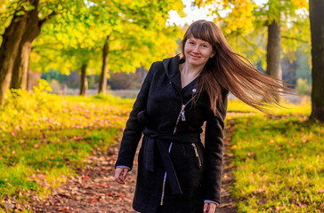 Girl on a walk in the autumn Park . Autumn park. Walk. Young girl.