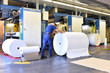 © lyzs/Westend61 - Man moving paper roll in a printing shop