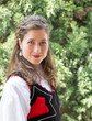 © Maria Breuer/Westend61 - Portrait of smiling woman wearing traditional Hungarian costume