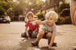 © Mareen Fischinger/Westend61 - Children using sidewalk chalk in their neighborhood