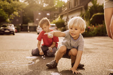 Children Using Sidewalk Chalk In Their Neighborhood