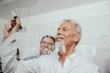 © Mareen Fischinger/Westend61 - Two men writing onto glass wall in office