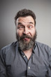 © Mimafoto/Westend61 - Portrait of a mature man with full beard pulling faces