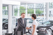 © Milton Brown/Westend61 - At the car dealer, Salesman and client shaking hands