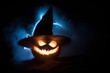 © zef art - Halloween pumpkin smile and scary eyes for party night. Close up view of scary Halloween pumpkin with eyes glowing inside at black background.