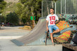 © Cavan Images - Young man is on a skate court with his skateboard