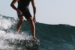 © Cavan Images - Action of lower part of man surfer on longboard nose