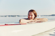 Young Woman Laughing On Standup Paddle Board In Casco Bay, Maine