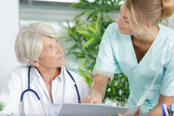 Wall Mural - doctor and nurse talking in hospital