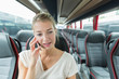 © auremar - woman alone on bus using smartphone