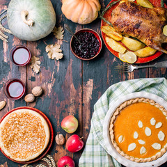 Wall Mural - Thanksgiving whole roast turkey, pumpkin and apple pie on a wooden table