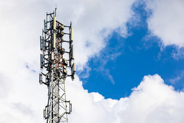 A low angle view of a thick and generously equipped GPS antenna with satellite equipment used in data exchange, associated with EMF pollution.