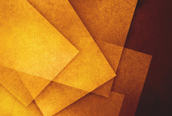 abstract orange background in gold and yellow shades, random textured rectangles squares and triangle shapes in geometric pattern background, golden hues with textured shapes on dark background