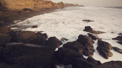 Wall Mural - Bali, Pura Tanah Lot temple foreland ocean surf swash at the sunset time