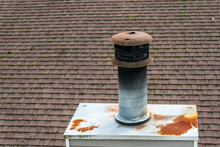 Suburban Rooftop, Mossy Asphalt Shingles, Rusty Chimney And Chimney Cap
