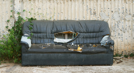 A broken old black sofa