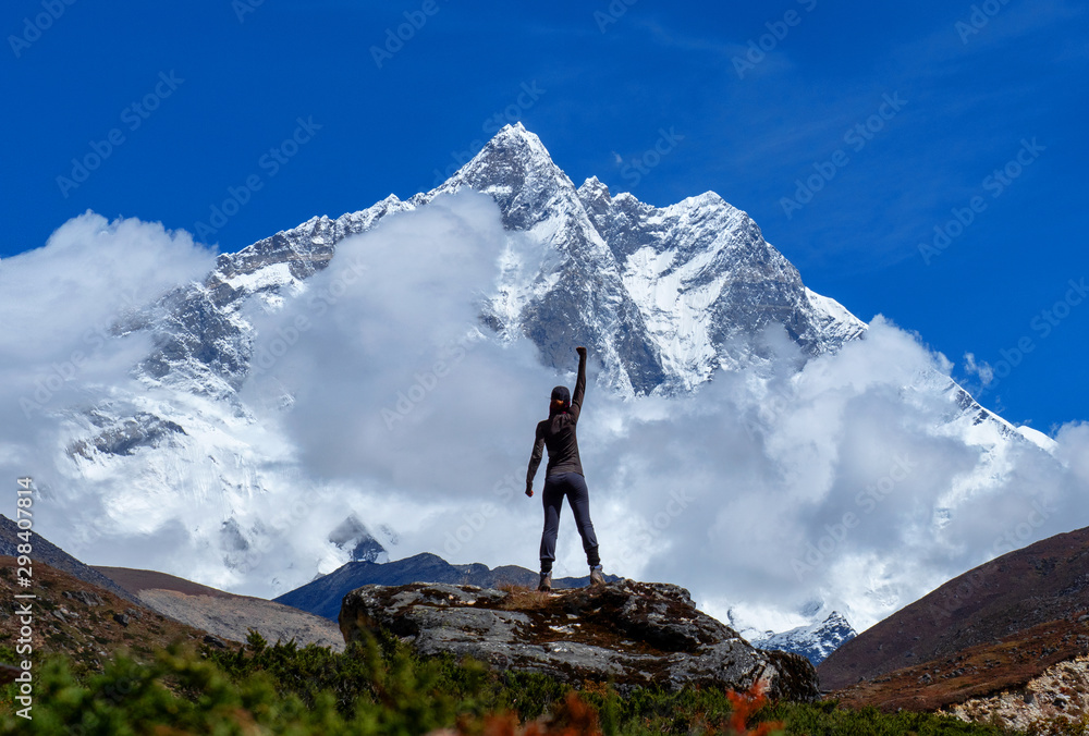 Active hiker hiking, enjoying the view, looking at mount Everest landscape. Travel sport lifestyle concept - obrazy, fototapety, plakaty 