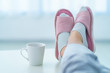 Cozy soft comfortable home slippers on female legs