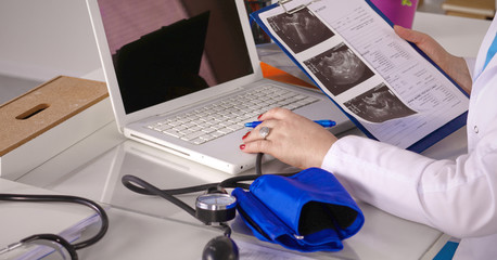 Wall Mural - Female doctor at the desk in the office