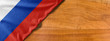National flag of Russia on a wooden background with copy space