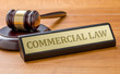 A gavel and a name plate with the engraving Commercial law
