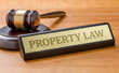 A gavel and a name plate with the engraving Property Law