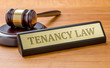 A gavel and a name plate with the engraving Tenancy Law