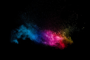 Wall Mural - Colorful powder explosion on black background. Abstract pastel color dust particles splash.