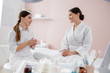 © Yakobchuk Olena - Beautician talking with young woman at wellness center