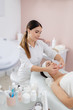 © Yakobchuk Olena - Charming young woman having face massage at beauty salon