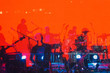 © APHOTOSTUDIO - Blurred Background, Musical Rock Band Performs On Stage In The Light Of Spotlights, Rock Music Night Concert.