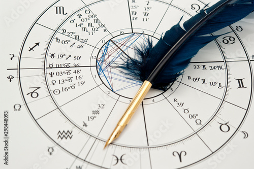 Cuadros en Lienzo quill pen in form ob blue feather lying on horoscope and zodiac signs like astro