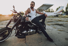 Handsome Biker Is Posing On His Motorcycle